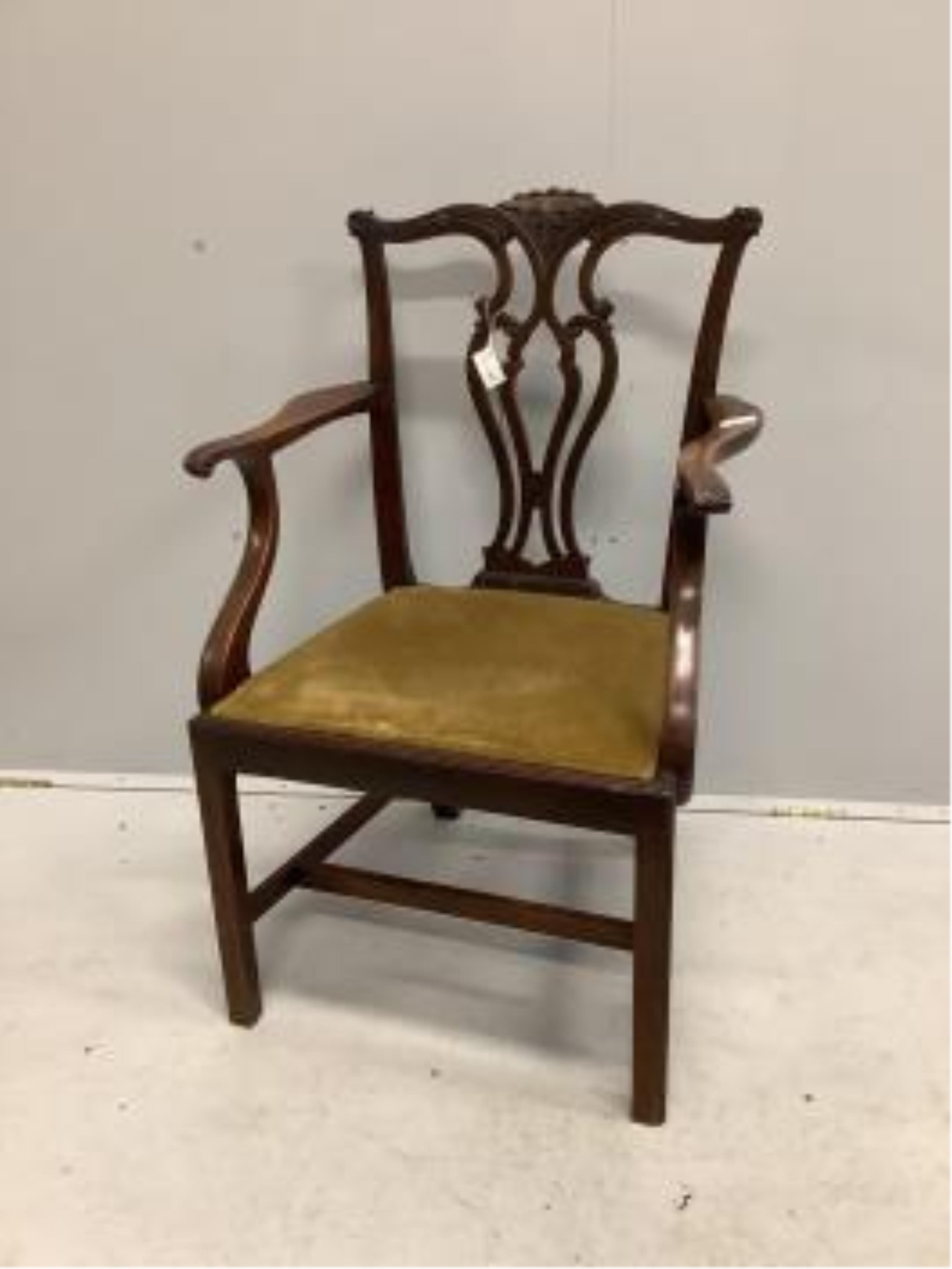 Four Chippendale style mahogany dining chairs, with pierced, interlaced splats above old gold velour drop in seats, one with arms. Condition - fair